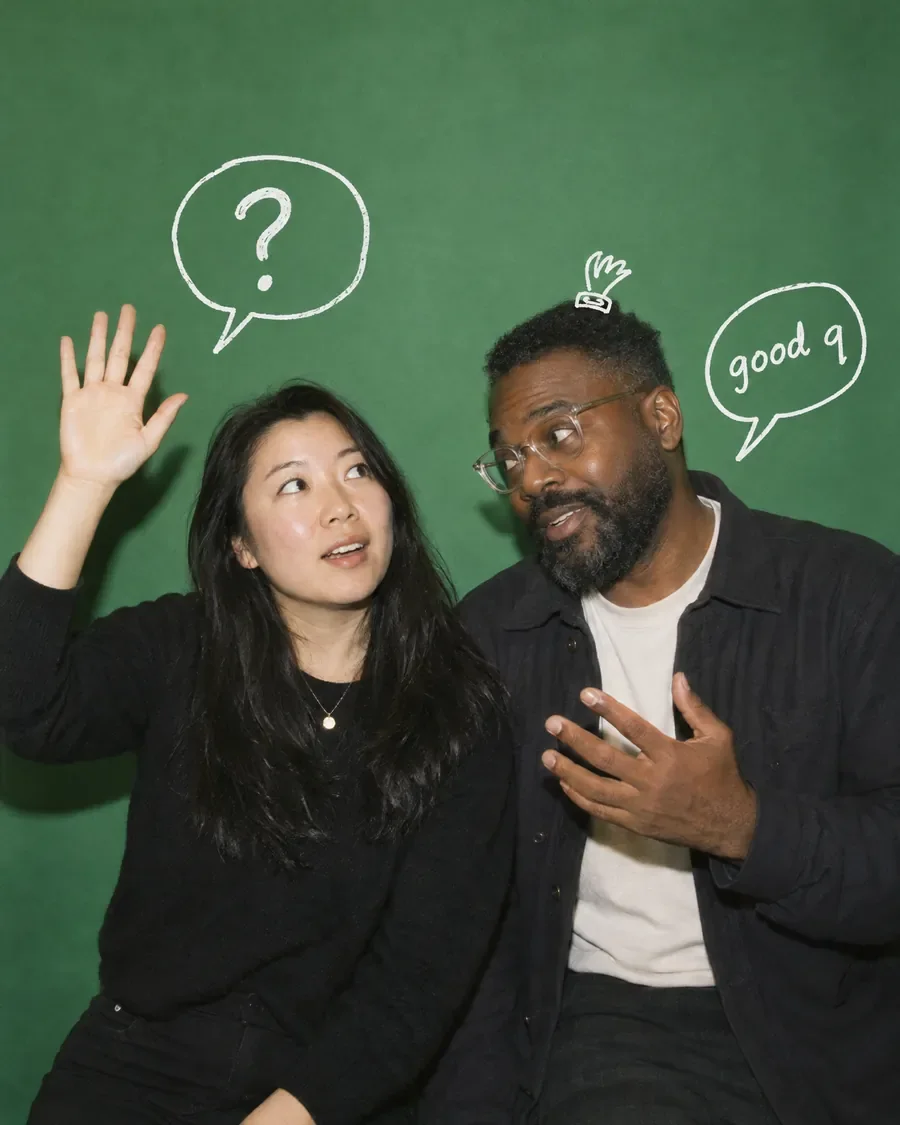 One co-founder raises her hand with a question while the other leans in, a doodled "good q" beside him.
